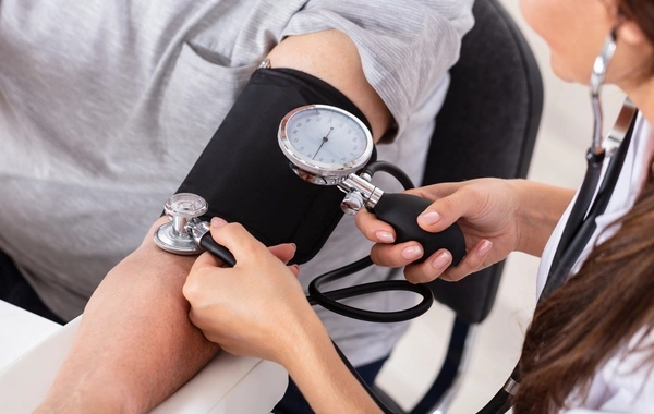 What symptom indicates that you need to closely monitor your blood pressure?